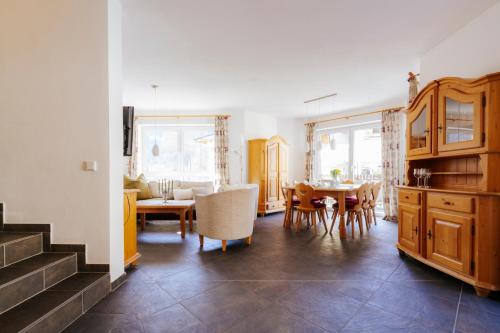 a kitchen and dining room with a table and chairs at Ferienhaus mit Sauna in Bad Gastein