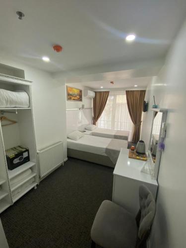 a small room with a bed and a desk and a room with a bed sqor at Beyhan Hotel in Istanbul