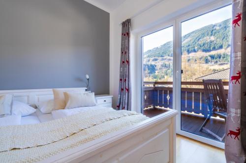 a bedroom with a bed and a large window at Ferienhaus mit Sauna in Bad Gastein