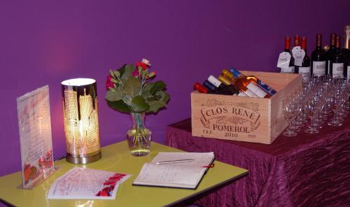 a table with wine glasses and a box of wine bottles at L'Horizon des Landes in Doazit