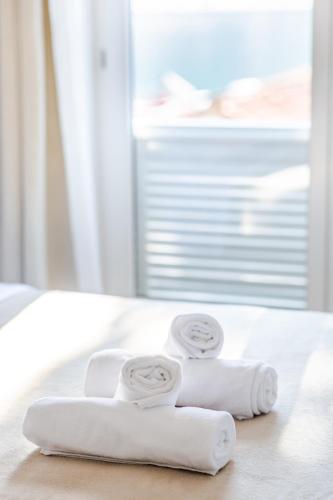 two rolls of towels sitting on a bed at Orsan Residence Apartment in Dubrovnik