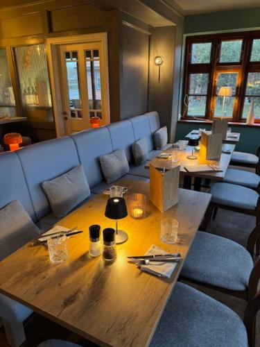 a dining room with a wooden table and chairs at Christiansand in Norddorf