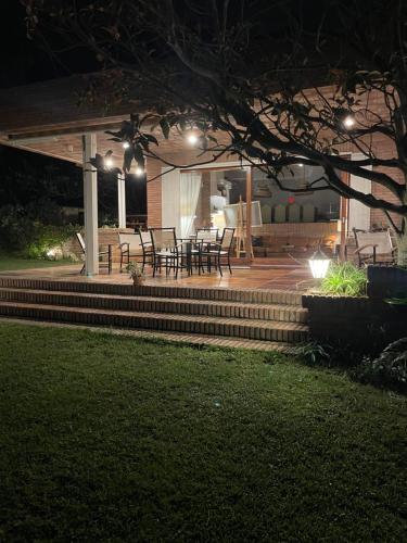 a patio with tables and chairs at night at Villa Juny Best view in North Barcelona Coast in Cabrils