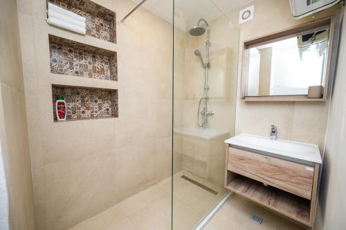 a bathroom with a shower and a sink at Modern 1 BDR with Balcony in Sarajevo