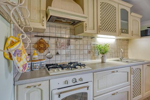 a kitchen with a white stove and a sink at Apartment Marta Slovenia Natures - Happy Rentals in Levpa