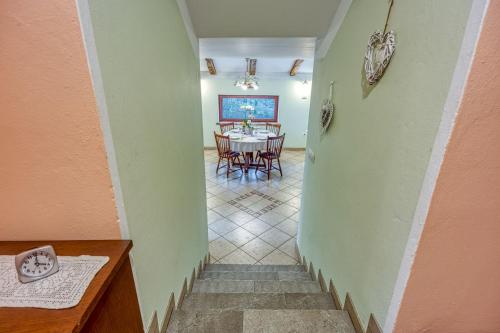 a hallway with a table and a dining room at Apartment Marta Slovenia Natures - Happy Rentals in Levpa