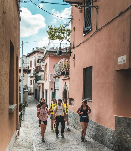a group of people walking down a street in an alley at Wellness Holiday Home in Brunate