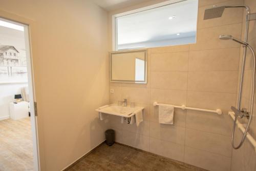 a bathroom with a sink and a window at Havelpension in Rathenow