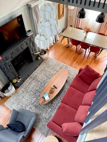 a living room with a couch and a surfboard at Pocono Chalet,Hot Tub,Arcade,Fireplace, Lake,Pool, Pet friendly, near Jim Thorpe No extra fees to use amenities in Towamensing Trails