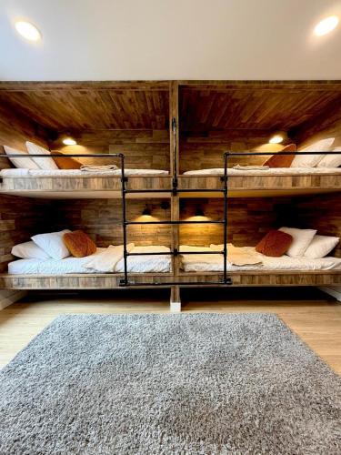 two bunk beds in a room with a rug at Pocono Chalet,Hot Tub,Arcade,Fireplace, Lake,Pool, Pet friendly, near Jim Thorpe No extra fees to use amenities in Towamensing Trails