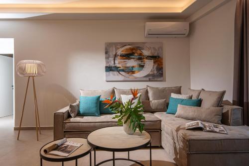 a living room with a couch and a table at Theatro Living in Elegance - Luxury Apartments in Hersonissos in Hersonissos
