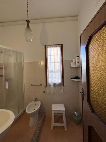 a bathroom with a sink and a toilet and a shower at Casa sulla Piazzetta in Olbia