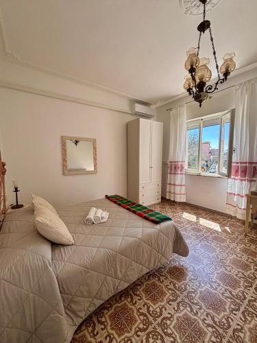 a bedroom with a bed and a large window at Casa sulla Piazzetta in Olbia