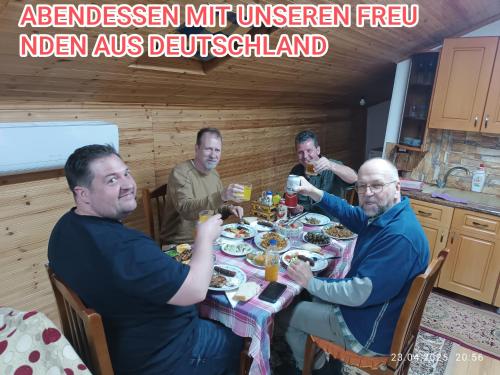 a group of men sitting around a table eating food at Samuela Cozy Retreat in Berat