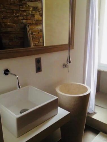 une salle de bain avec un lavabo et un miroir dans l'établissement T2 pied dans l eau, à Ajaccio