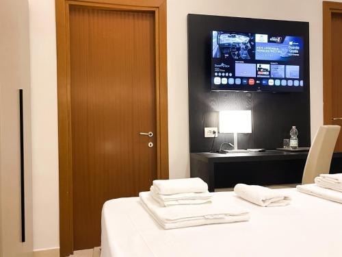 a room with a table with a tv on the wall at Brain Living Pagani in Pagani