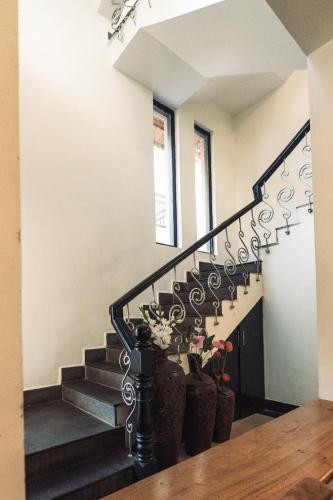 a staircase in a house with potted plants at VILLA M - LAGOON 4 Calangute 3BHK Pool Facing, Breakfast Included in Old Goa