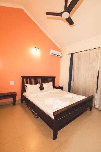 a bedroom with a bed with a ceiling fan at VILLA M - LAGOON 4 Calangute 3BHK Pool Facing, Breakfast Included in Old Goa