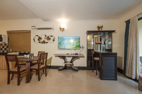 a kitchen and dining room with a table and chairs at VILLA M - LAGOON 4 Calangute 3BHK Pool Facing, Breakfast Included in Old Goa