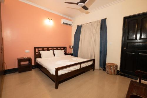 a bedroom with a bed and a ceiling fan at VILLA M - LAGOON 4 Calangute 3BHK Pool Facing, Breakfast Included in Old Goa