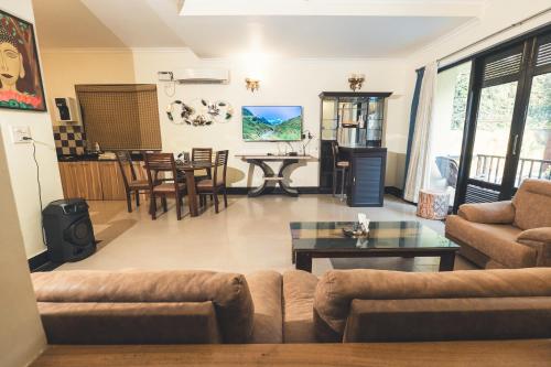 a living room with a couch and a table at VILLA M - LAGOON 4 Calangute 3BHK Pool Facing, Breakfast Included in Old Goa