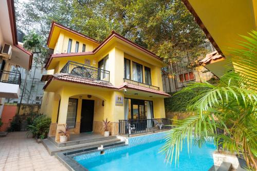 a house with a swimming pool in front of it at VILLA M - LAGOON 4 Calangute 3BHK Pool Facing, Breakfast Included in Old Goa