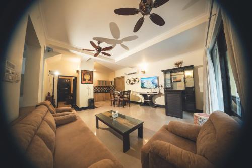 a living room with a couch and a table at VILLA M - LAGOON 4 Calangute 3BHK Pool Facing, Breakfast Included in Old Goa