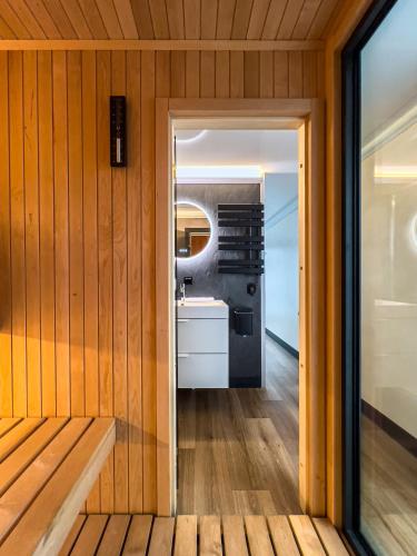 a room with wood paneling and a door leading into a bathroom at L'Escale Royale Saverne - Rhin - Strasbourg in Saverne