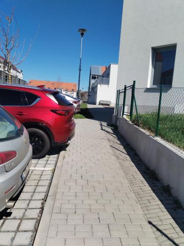 two cars parked on a sidewalk next to a building at Vicemilice byt in Vyškov