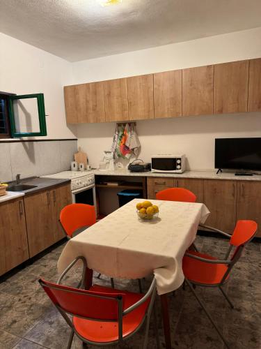 a kitchen with a table with oranges on it at Lorena Rooms in Risan