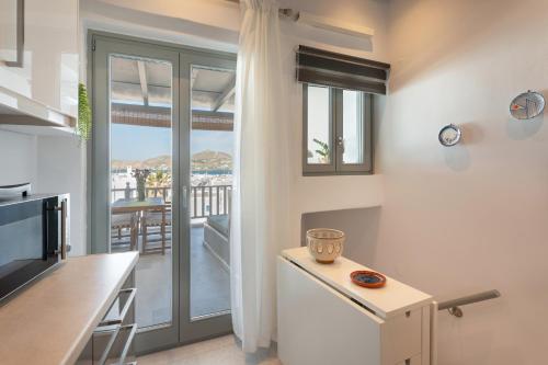 a kitchen with a view of a balcony at Caper-2 Bedroom traditional home with amazing view in Naousa