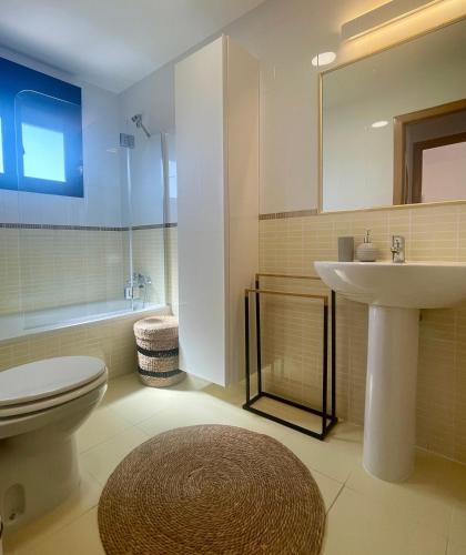 a bathroom with a toilet and a sink at El Nido del Sol in La Oliva