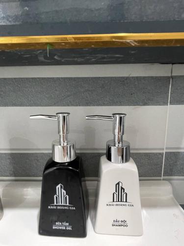 two complimentary bottles of hair products sitting on a sink at Hoàng Gia 2 Hotel in Ấp An Phú
