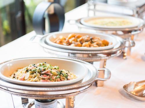 a row of plates of food on a table at LiVEMAX Amms Canna Resort Villa in Ginoza