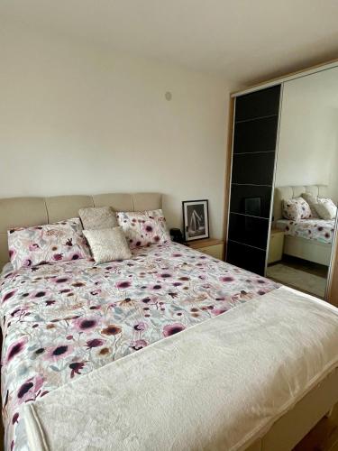 a bedroom with a large bed with pink flowers at Wine story in Irig
