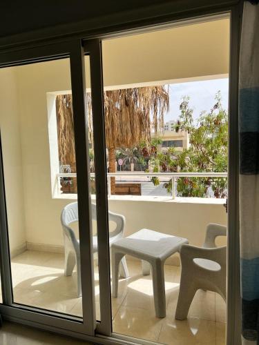 a view of a balcony with a table and chairs at Sea Life Apartments-hotel in Hurghada