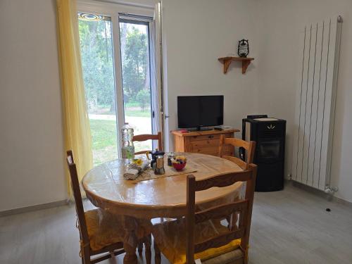 a dining room with a table and a television at Casa vacanze Le cicale in Pesaro