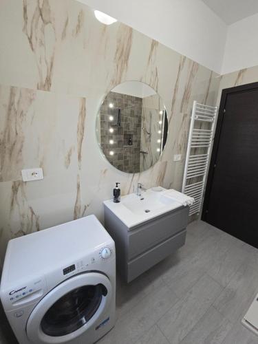 a bathroom with a washing machine and a washer at Casa vacanze Le cicale in Pesaro