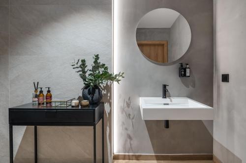 a bathroom with a sink and a mirror at Muse - LoftAffair Spa Collection in Kraków