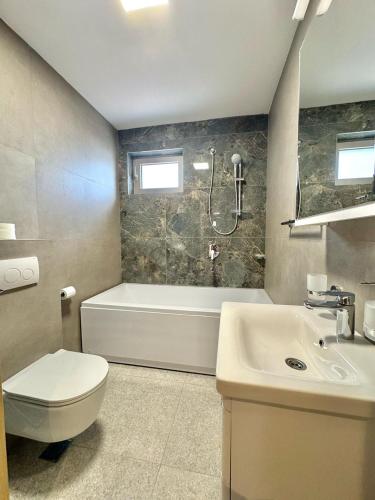 a bathroom with a toilet and a sink and a shower at Luxury Apartments Przno in Budva
