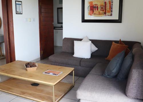 a living room with a couch and a coffee table at Mount Savannah Lodge by Dream Resorts in Krugersdorp