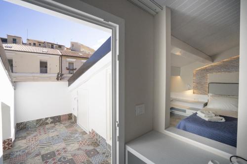 a room with a balcony with a bed and a window at Franco's House Tropea in Tropea