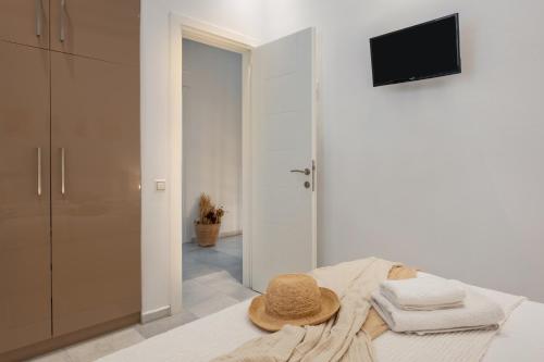 a hat sitting on top of a bed in a room at Caper-2 Bedroom traditional home with amazing view in Naousa