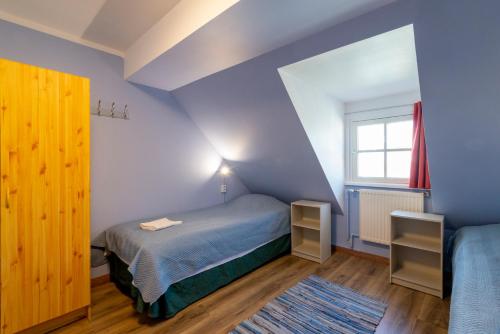 a small bedroom with a bed and a window at 16eur - Old Town Munkenhof in Tallinn