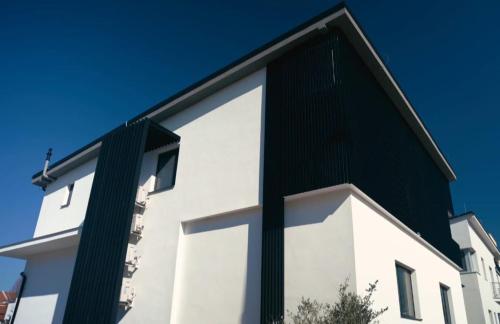 a large white building with a large window at Apartmán Kubko in Levice