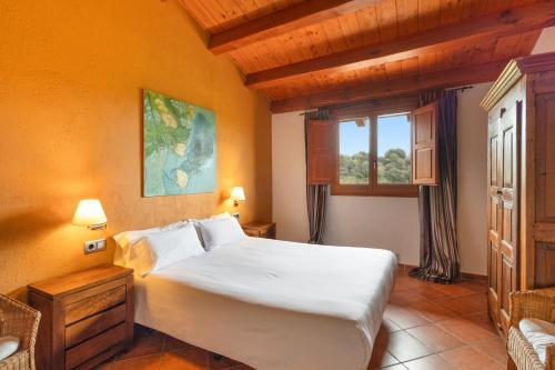a bedroom with a large bed and a window at La Serreta in Gironella