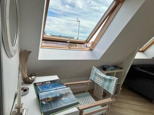 a room with a window and a desk with a chair at Appartement de charme à Étel, vue mer, 2 chambres - FR-1-479-220 in Étel