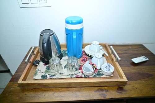 a table with a tray with a coffee maker and cups at Idar Haveli in Jodhpur