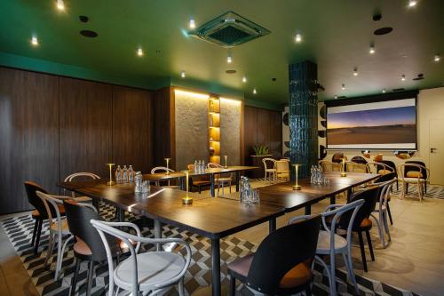 a dining room with a large table and chairs at Gold Hotel in Złotoryja