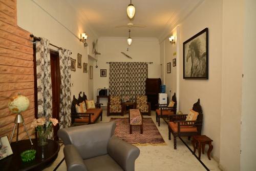 a living room with couches and chairs at Idar Haveli in Jodhpur